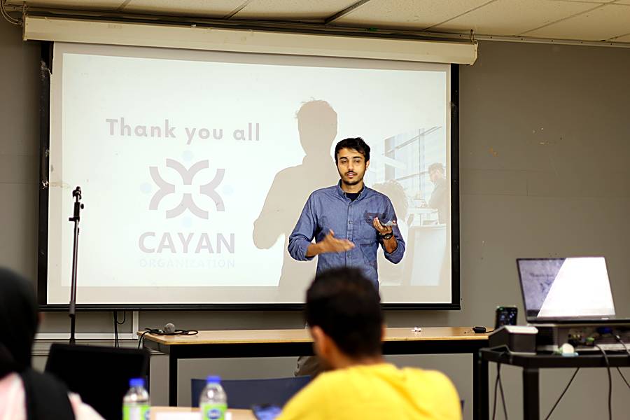 A presenter speaking during a Cayan session