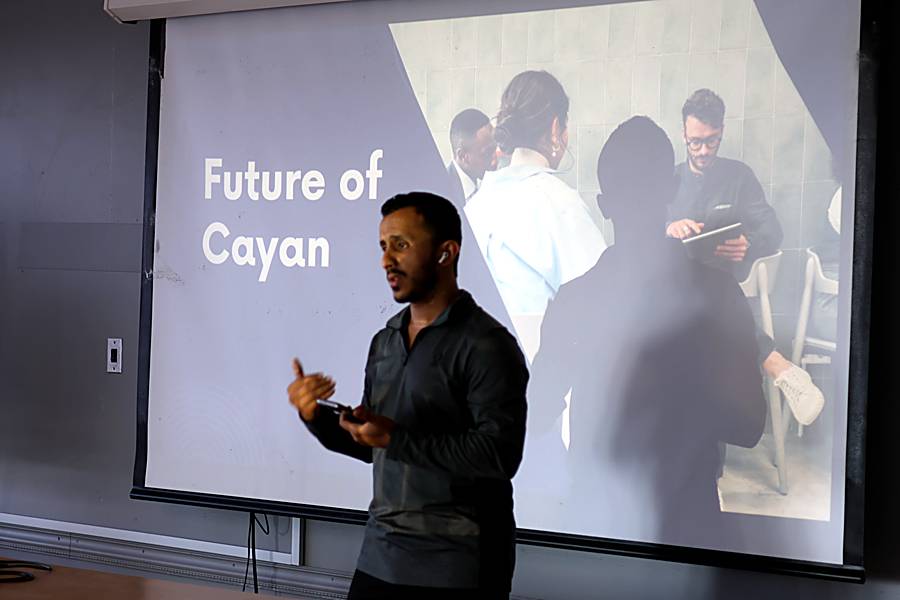 A presenter beside the Future of Cayan slide